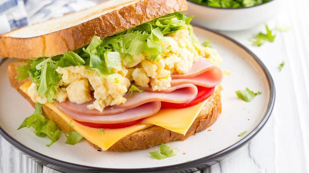 The Ham & Cheese Scrambled Eggs · Sizzling fresh ham, eggs and cheese scrambled eggs. Served with side of hash browns, house potatoes, cottage cheese or fruits and side of toast.