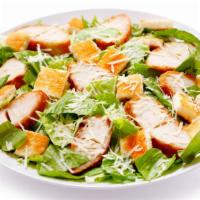 Chicken Caesar Salad · Grilled chicken breast added on top of romaine lettuce, croutons, and Parmesan cheese.