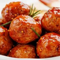 Juicy Meatballs · Four pieces of our house-made meatballs with marinara sauce on the side.