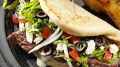 Beef Gyro · Served on flatbread. Includes lettuce, tomato, onions and tzatziki sauce.