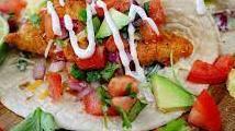 Fish Taco · Grilled Salmon topped with mixed salad, salsa, cheddar cheese, green onion and chipotle sauc...