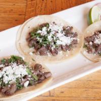  Carne Asada Tacos  · Topped with cilantro and queso fresco. Served with avocado cilantro salsa on the side.
