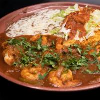 Camarones Rancheros · Prawns sautéed in butter with Chef Ramon's spicy tomato, pepper and onion sauce. Served with...