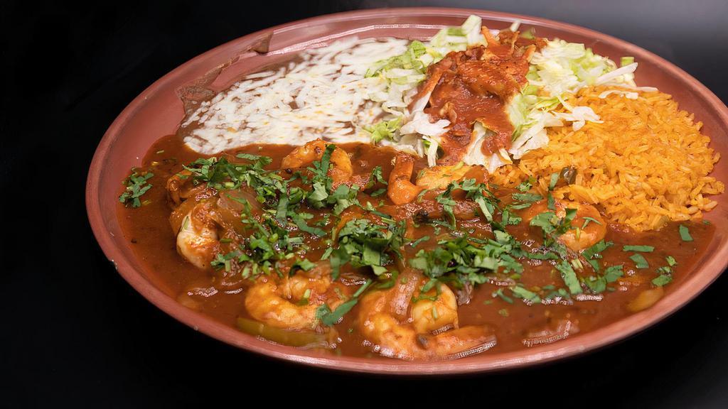 Camarones Rancheros · Prawns sautéed in butter with Chef Ramon's spicy tomato, pepper and onion sauce. Served with rice, refried beans and salad.