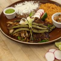 Pork Carnitas Plate  · Tender marinated and shredded slow roasted pork served with rice and beans. Served with rice...