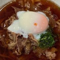 Niku Udon · Simmered Washu beef, onion and poached egg with udon noodle in dash broth.