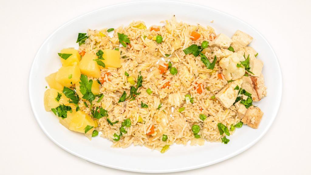 Pineapple Fried Rice Bowl · Rice fried with Eggs, Onions, Carrots, Peas, Cabbage, Pineapple and choice of Proteins.  Served with choice of sauce. Garnished with Cilantro and Green Scallions.