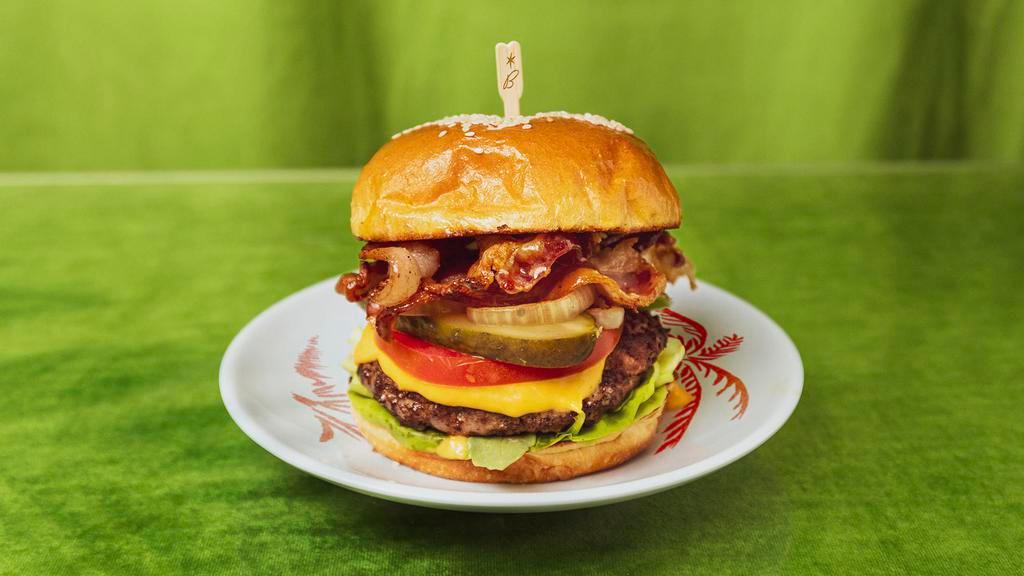 Bacon Burger · Bacon cheeseburger with lettuce, tomato, pickles, caramelized onions and mayo.
