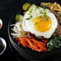 Dolsot Bibimbap · Our signature hot stone rice bowl with seasonal vegetables and rice with choice of your prot...