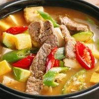 Doenjang Jjigae · Soybean paste stew with seasonal vegetables and tofu. Served with steamed rice.