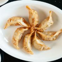 Pot Stickers (4 Pieces) · Deep fried dumpling with vegetables and meat inside.