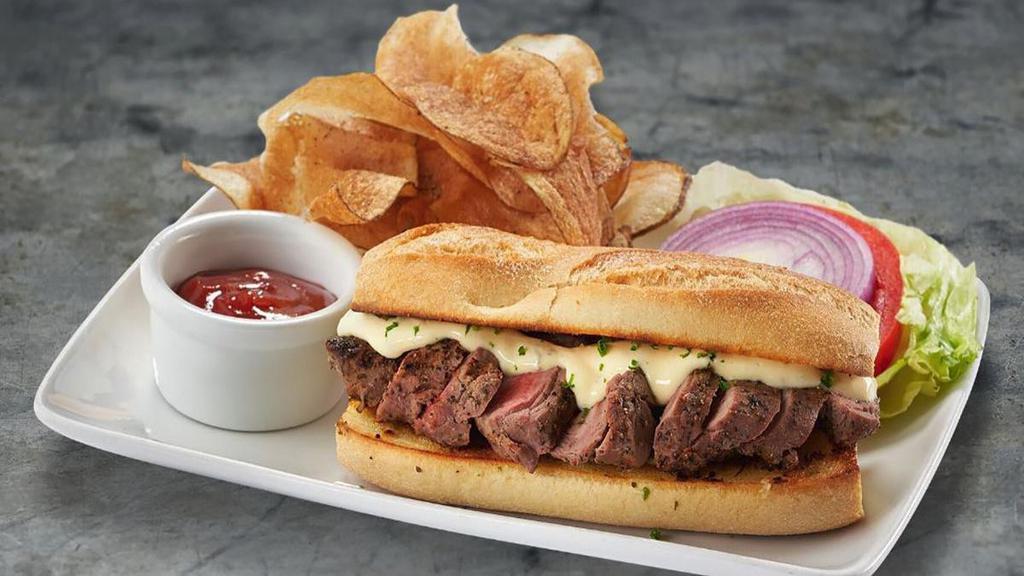 Steak Sandwich · sliced filet, horseradish cream, garlic bread, hand-cut potato chips