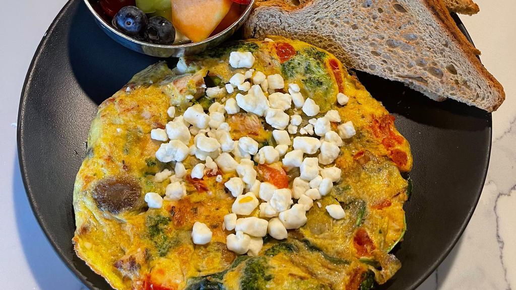 Chicken Frittata  · Eggs, grilled chicken, goat cheese, artichoke hearts, sautéed mushrooms, spinach, broccoli, tomatoes & onions.
