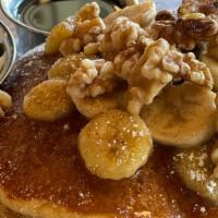 Pancake Banana Flambe · Stack of 3 pancakes topped with rum-caramelized & fresh sliced bananas & walnuts. Dusted wit...