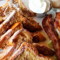Le Combo French Toast · 6 pieces of brioche, choice of 3 strips of Applewood smoked bacon, 3 link sausages or 2 coun...