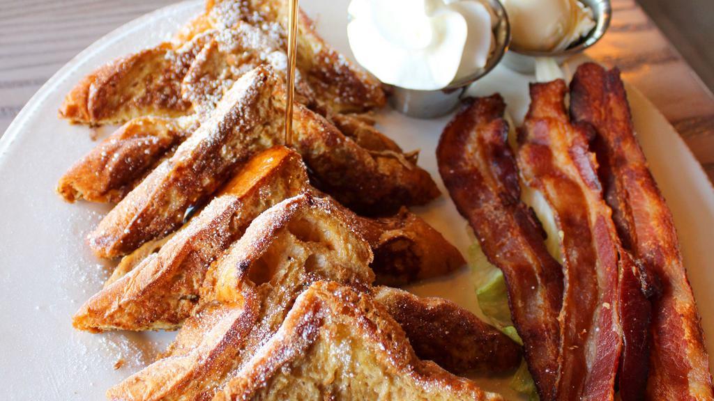 Le Combo French Toast · 6 pieces of brioche, choice of 3 strips of Applewood smoked bacon, 3 link sausages or 2 country sausage patties.