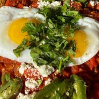 Shakshouka · Two scrambled or fried eggs on a spicy sauce of stewed tomatoes, onions, red peppers & garli...