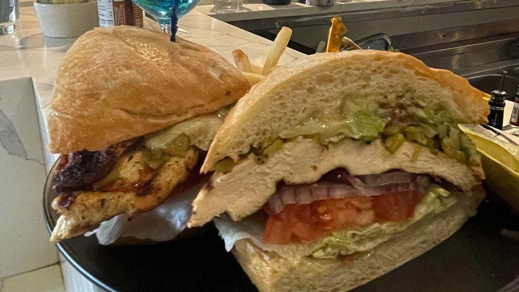 Chicken Guacamole Sandwich · Blackened chicken breast, bacon, fresh guacamole, Jack cheese, roasted chili peppers, onions, tomatoes & lettuce on a Ciabatta roll.
