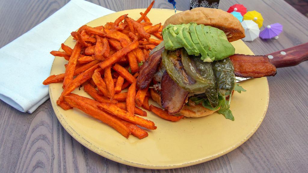 Crumbs Spicy Burger · Applewood smoked bacon, Monterey Jack avocado, grilled jalapeños, arugula, tomato, pickles & caramelized red & yellow onions, topped with chipotle aioli.