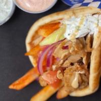 c. Beef / Lamb Pita Wrap · A seasoned beef and lamb mix, served on a warm pita bread filled with fries, tomatoes, onion...