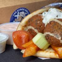 f. Falafel Pita Wrap · Six pieces of falafel served on a warm pita bread filled with fries, tomatoes, onions and tz...