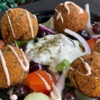 f. Falafel Greek Bowl · Deep fried falafel pieces with , red onions, tomatoes, cucumber and greek lemon rice topped ...