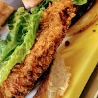 Fried Chicken Sandwich · Fried chicken, lemon aioli, pickles, romaine lettuce, house made beer bun & house cut French...