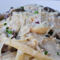 Wild Mushroom Fettuccine · Wild mushroom fettuccine made with homemade white wine cream sauce, parmesan cheese, and chi...
