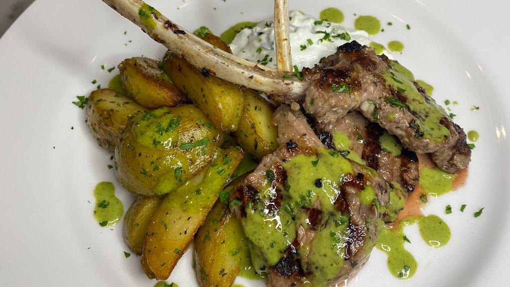Lamb Chops · Four Grilled Lamb Chop served with roasted golden potatoes,  housemade tzatziki, topped with our very own chimichurri
