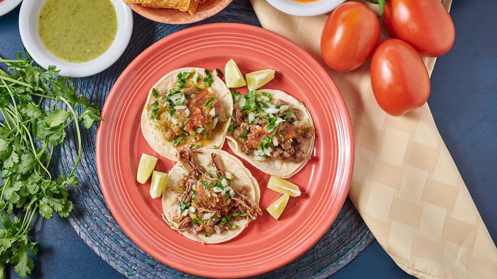 Regular Tacos · Choice of meat, cilantro, onions & salsa