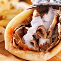 Lamb Shawarma with Fries Wrap · Fresh marinated lamb, crispy potato fries with spices wrapped in lavash bread and topped wit...
