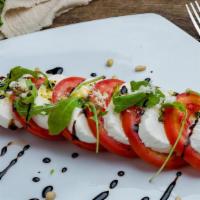 Caprese Salad · Mozzarella, fresh tomato salad with EVOO, basil, and balsamic vinegar reduction. <br />*EVOO...