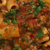 Rigatoni Paestum · tube pasta with homemade sausage, mushrooms, fresh chili in red sauce (spicy)
