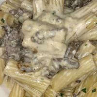 Rigatoni alla Norcina · Tube pasta, homemade sausage, onions, mushrooms in light cream sauce (mild spice)