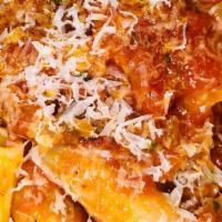Rigatoni All'amatriciana · tube pasta with guanciale, onions, in red sauce topped with pecorino romano cheese.