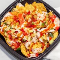 Tosticeviche · ceviche served with salsa verde tostitos chips, topped with hot sauce, lime, tajin