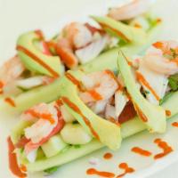 Ceviche Boats · Hollowed out cucumbers, topped with ceviche, lime, salt, hot sauce, and tajin.