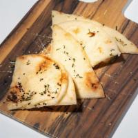 Kulcha Naan · One piece of buttered naan, topped with sesame seeds and mint. Contains gluten, dairy, soy, ...