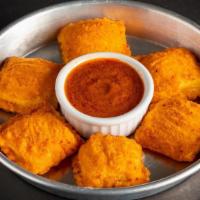 Holy Moly Fried Ravioli · Fried cheese ravioli with a tikka masala dip. Vegetarian. Contains gluten, dairy, and soy. W...