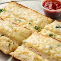 Cheesy Garlic Bread · Fresh baguette with housemade garlic butter, parsley and mozzarella cheese with a side of ho...