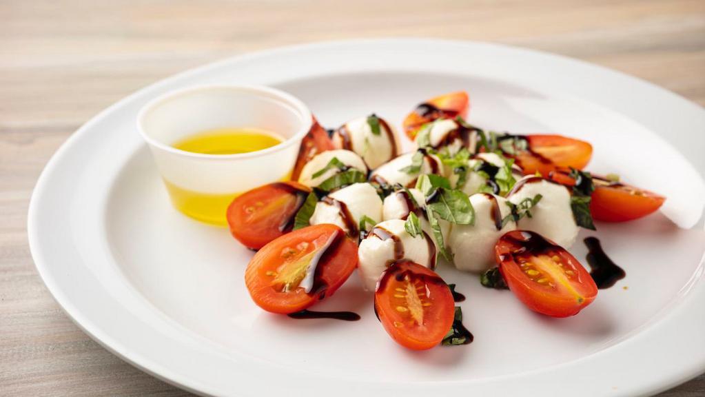 Caprese · New. Fresh mozzarella, baby heirloom tomatoes, basil pesto, balsamic glaze, fresh basil.