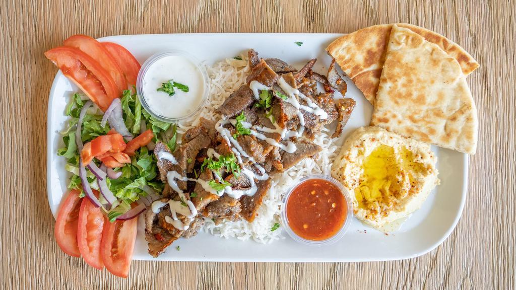 Gyro Platter  · Gyro meat served on a bed of rice, hummus, salad, pita bread with SAM's Tzatziki sauce.