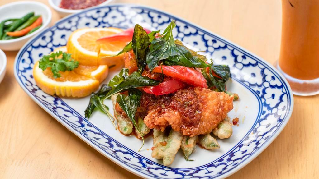 Pla Sam Ros · Spicy. Deep fried fillet of red snapper with fresh chili sauce, garlic, bell peppers and crispy sweet basil placed on a bed of crispy green bean.