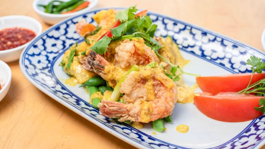 Yellow Prawns · Lightly fried jumbo prawns with garlic, onions,bell peppers mixed in a light yellow curry sauce, placed on a bed of green beans, topped with cilantro.