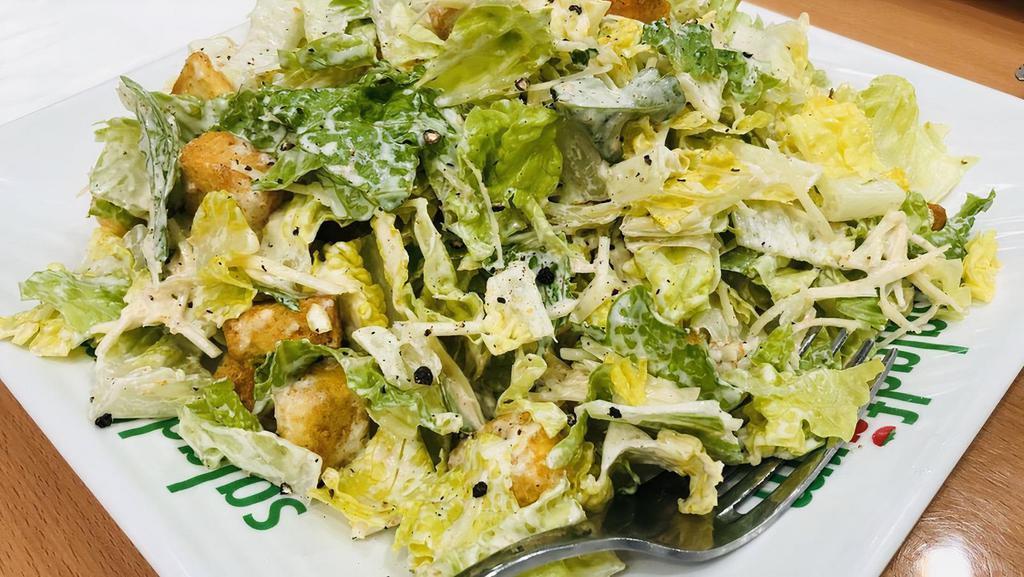 2. Caesar Salad · Crisp romaine hearts, baked seasoned croutons and shaved parmesan cheese served with our traditional creamy caesar dressing.