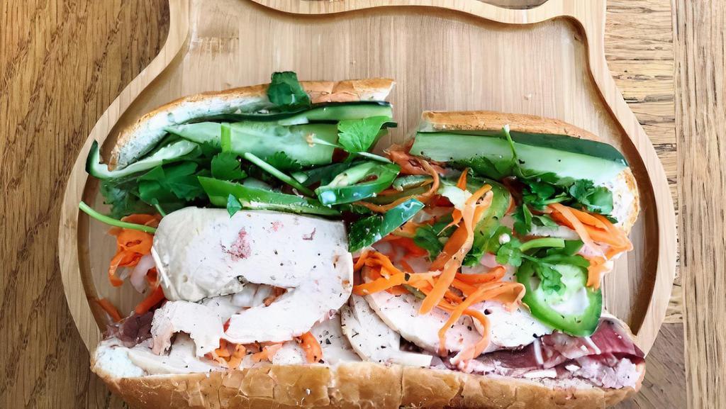 Banh Mi · Made with french roll, mayonnaise, picked carrots & daikon, jalapeno, cucumber, cilantro.