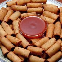 Lumpiang Shanghai, Pork & Shrimp - 2.5 lbs. (Frozen) · Bite-size spring rolls with ground pork & shrimp filling. Serve with our sweet-sour dipping ...