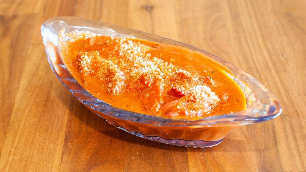 Butter Chicken · Yogurt and spice marinated chicken dressed butter, coconut based creamy tomato sauce herbes & spices.