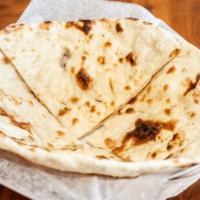 Butter Naan · Fresh bread baked in a clay oven topped with butter for taste and sweet aroma.