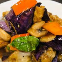 23 Eggplant Tofu · Asian eggplant wok-tossed with black bean sauce, mushroom, red bell, and basil.